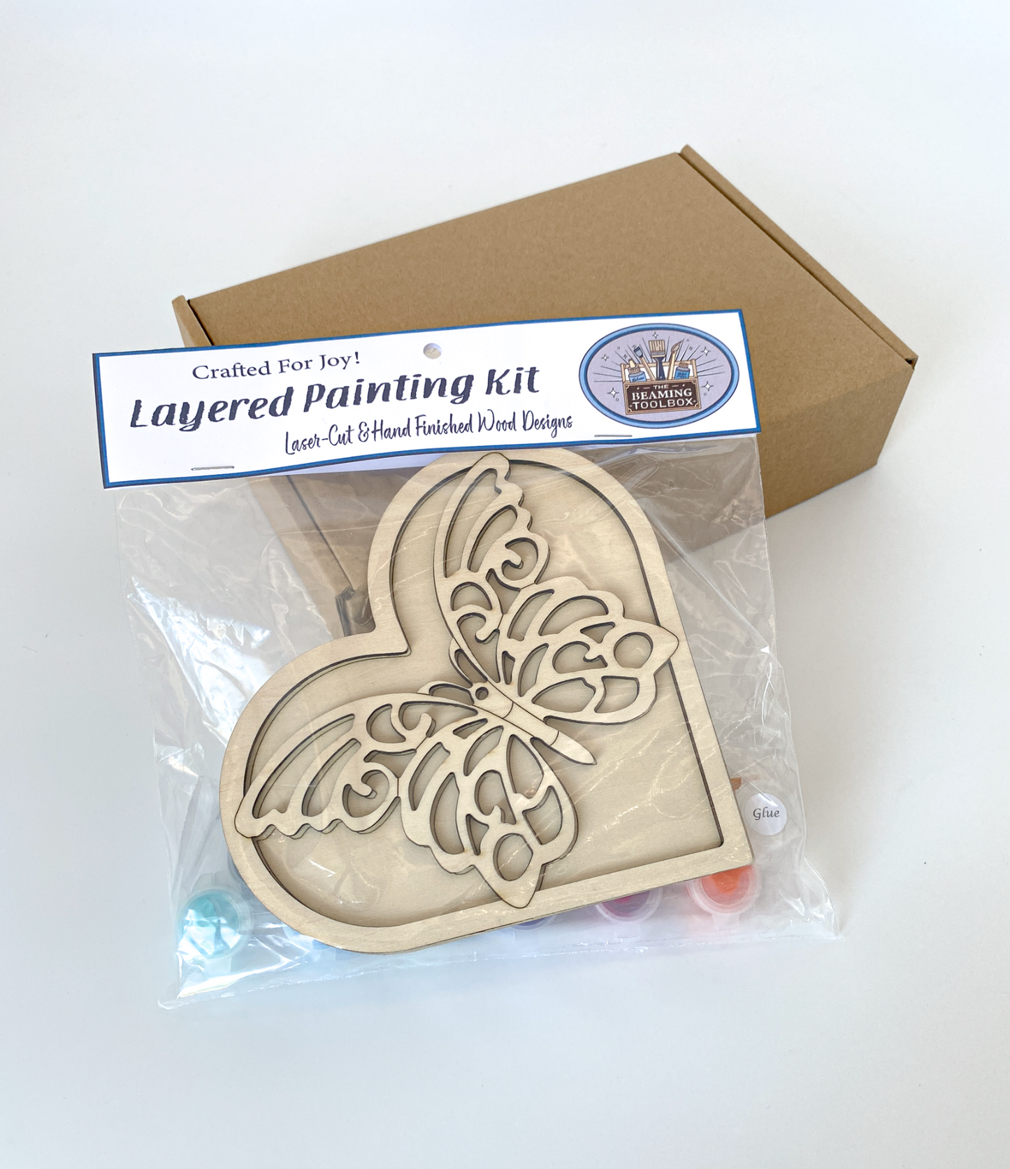 Layered painting kit with a heart-shaped wooden design and packaging on a white background