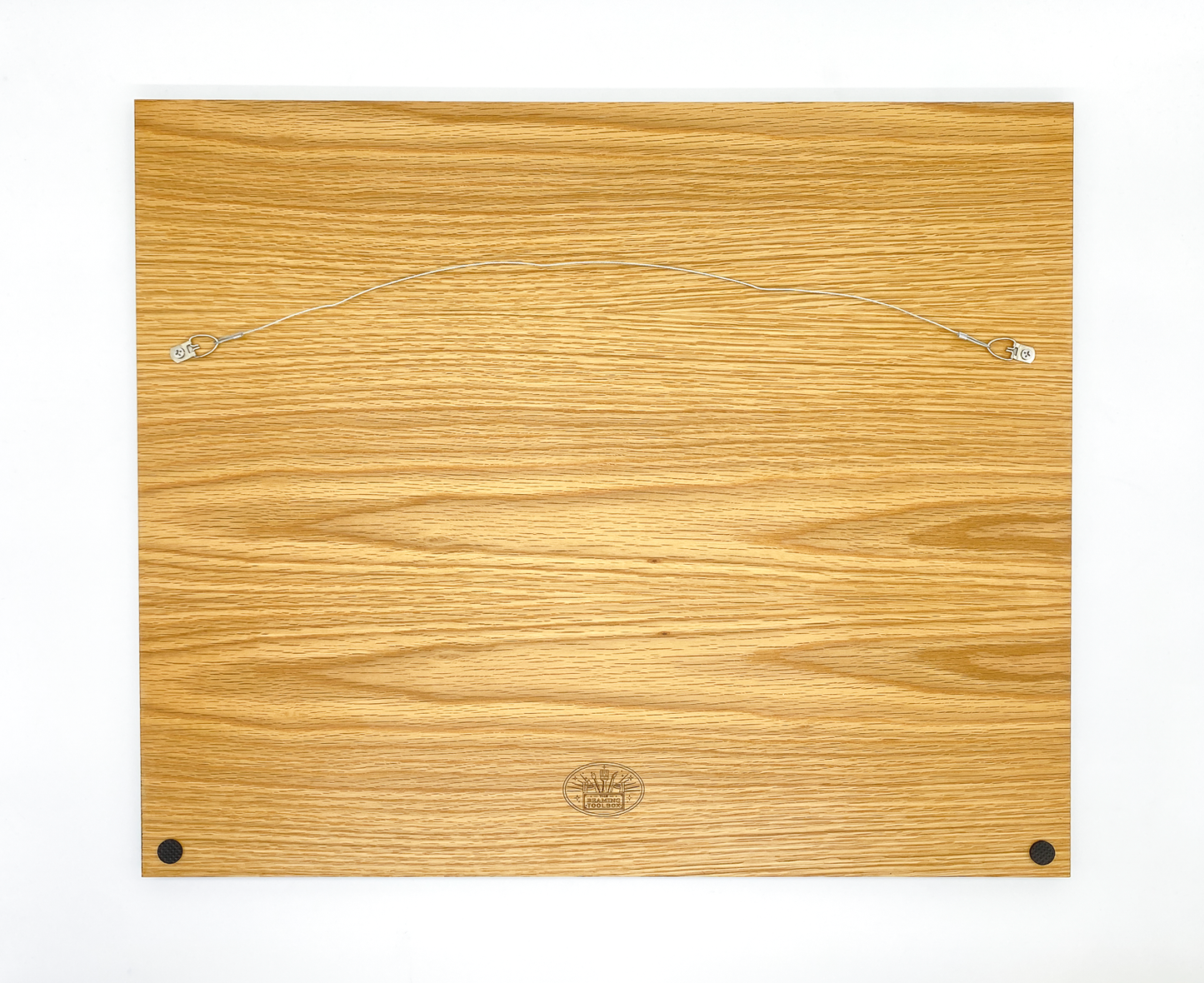 Reverse side of wood mountain art showing the Beaming Toolbox logo and sturdy hanging hardware