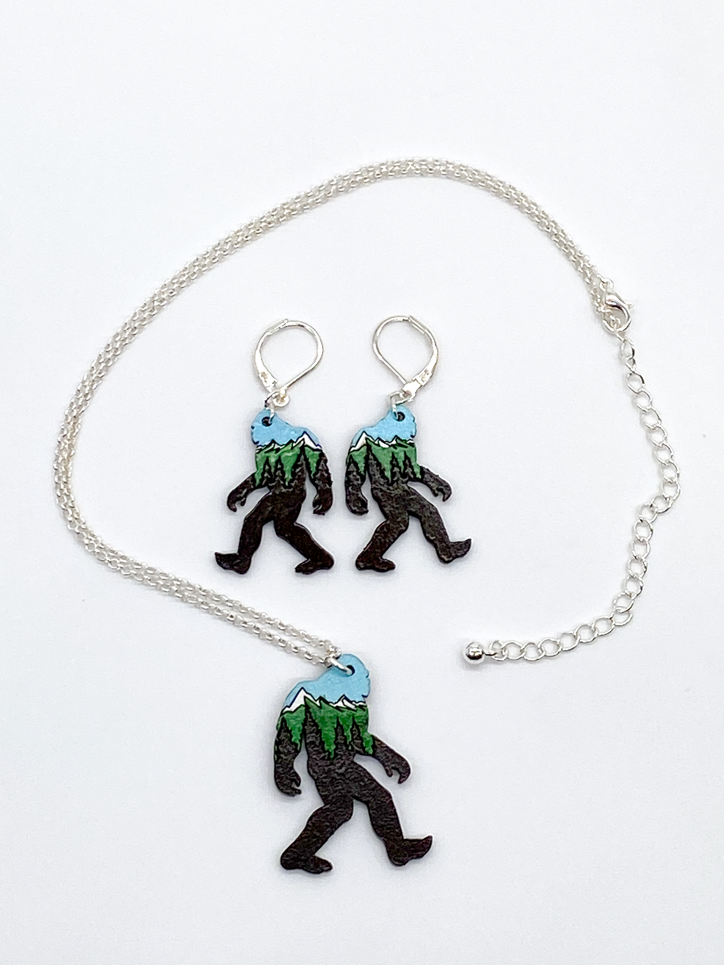 Necklace and earrings with sasquatch design on a white background