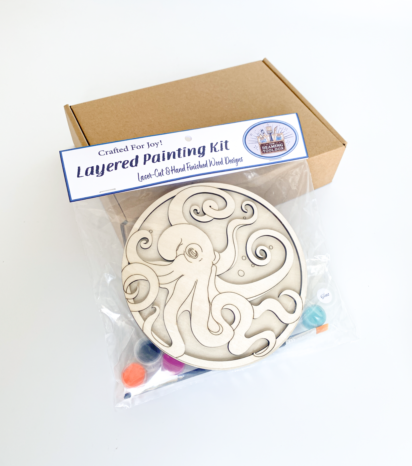 Layered painting kit with wooden design and packaging on a white background