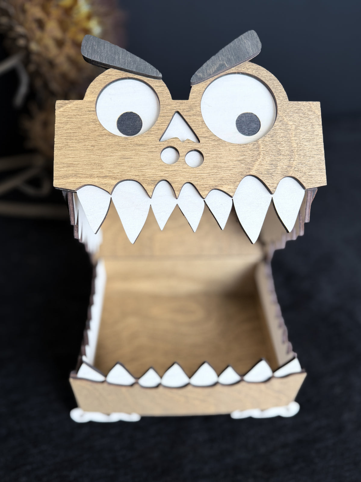 Walnut-stained wooden monster box with its hinged mouth fully open, showing the empty wooden storage compartment, white teeth, and googly eyes.