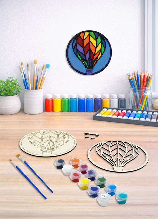 A multi-layer 3D hot air balloon wood kit shown with painting supplies and assembly hardware for home decor.