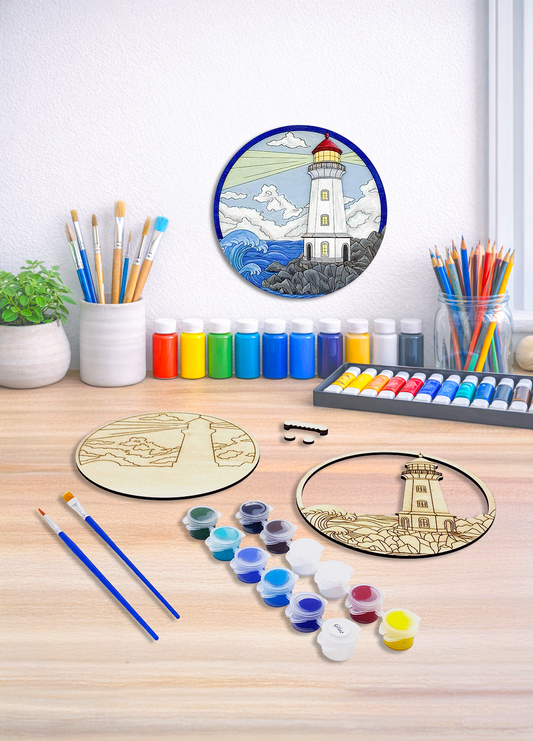 A nautical lighthouse 3D layered wood art kit displayed with brushes, paint, and a finished example on a white wall.