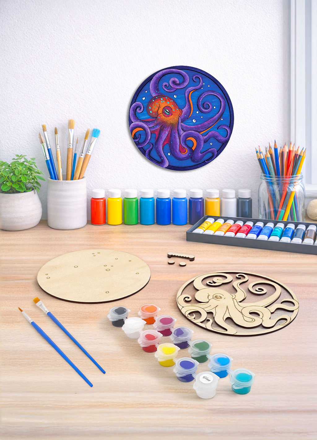 A 3D octopus wood art kit showing the unpainted layers, paint set, and hardware needed to create ocean decor.
