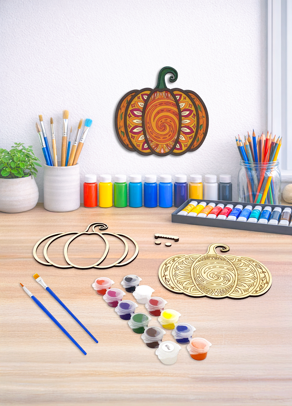 An intricate 3D mandala pumpkin wood art kit featuring laser-cut layers and a complete painting set for autumn decor.