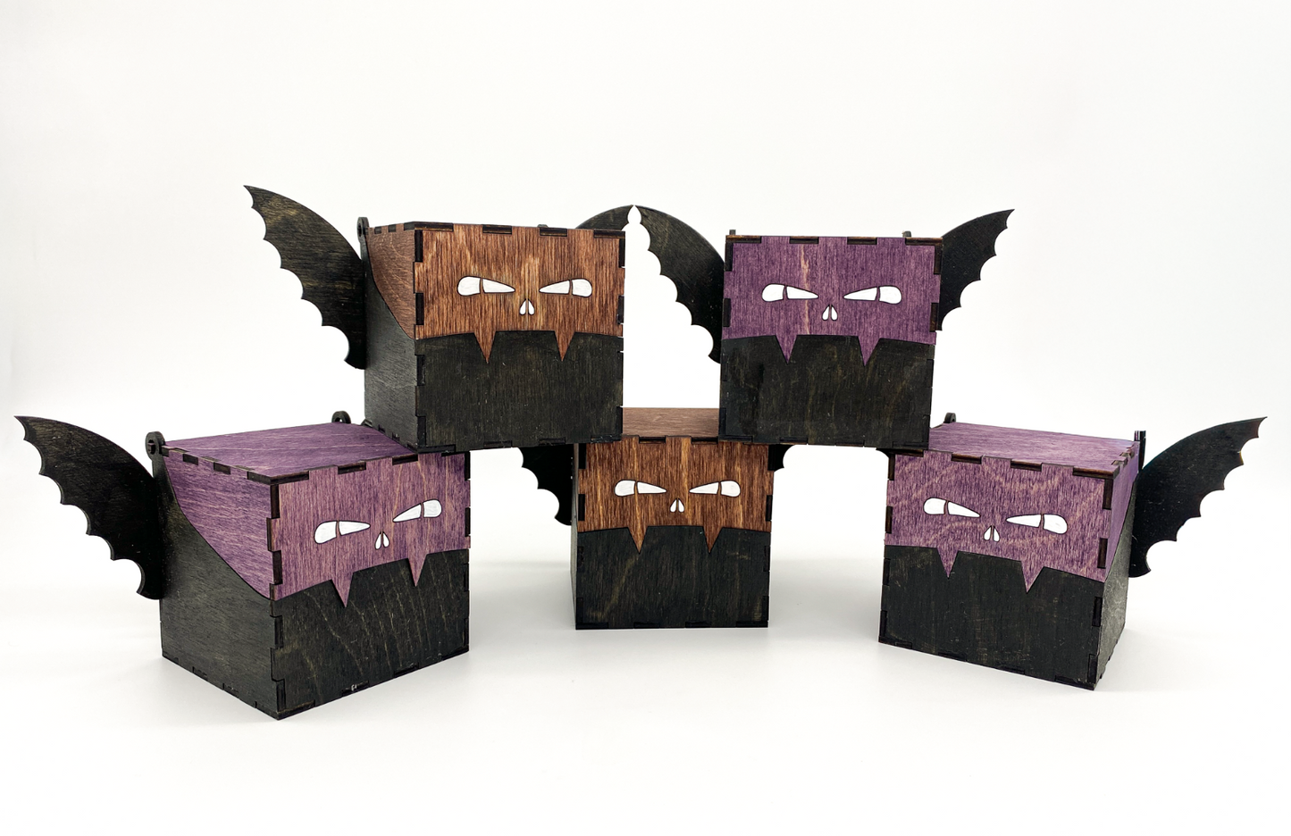 Handcrafted wooden bat boxs with engraved eyes and wings, stained in purple and mahogney