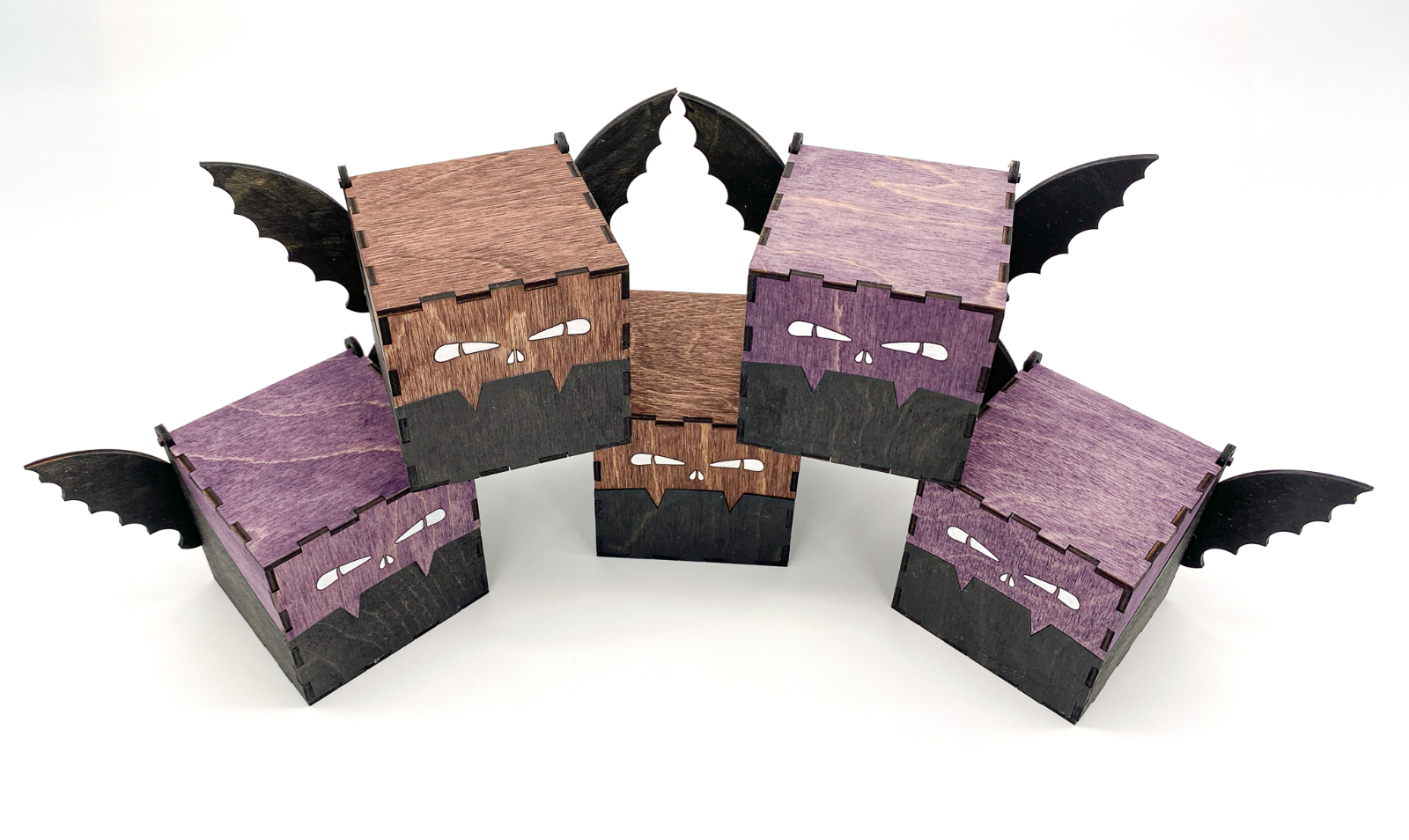 Top view of handcrafted wooden bat boxs with engraved eyes and wings, stained in purple and mahogney