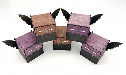 Top view of handcrafted wooden bat boxs with engraved eyes and wings, stained in purple and mahogney
