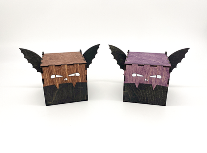 Handcrafted wooden bat boxs with engraved eyes and wings, stained in purple and mahogney