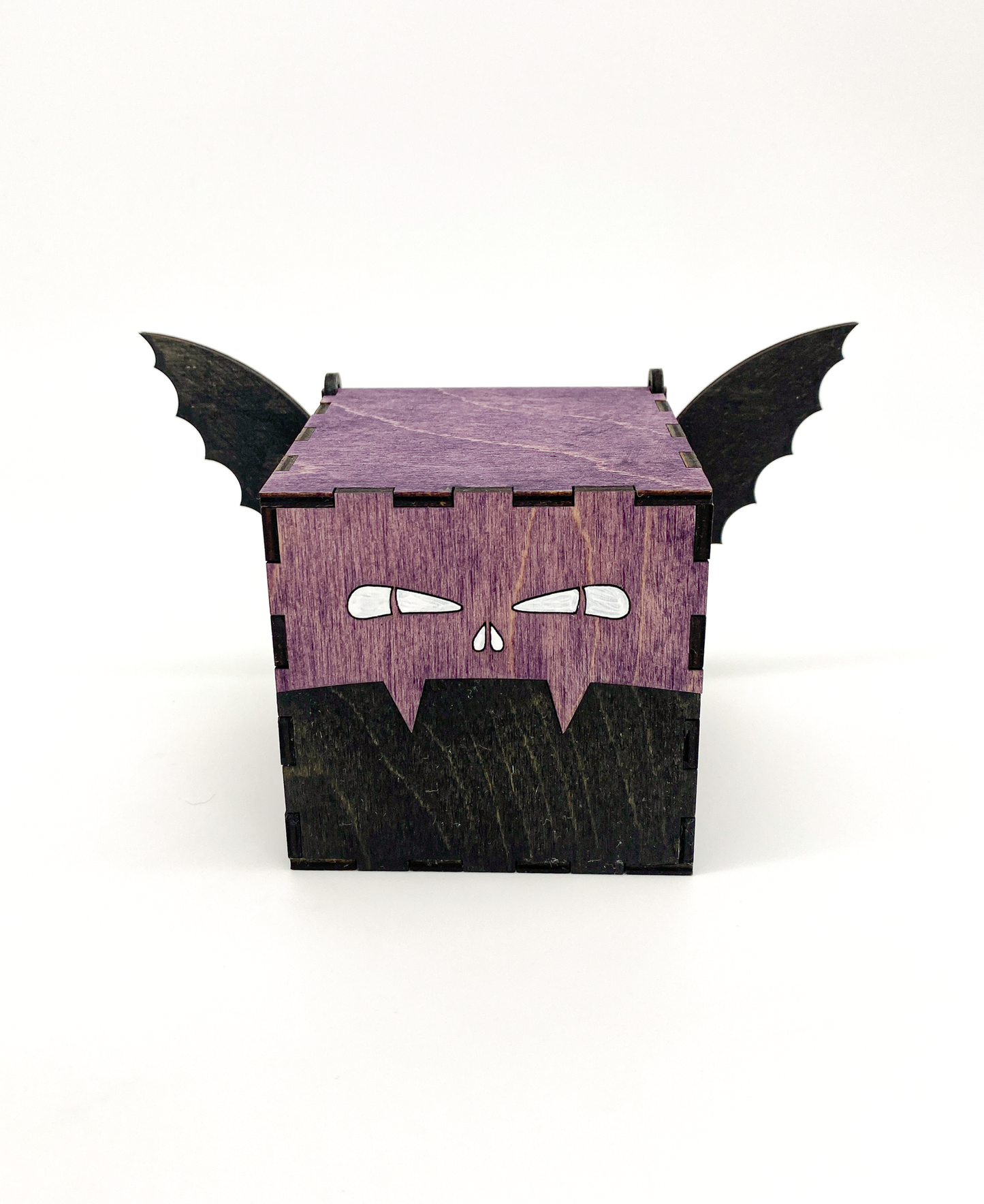 Wooden box designed to look like a bat with black wings on a white background