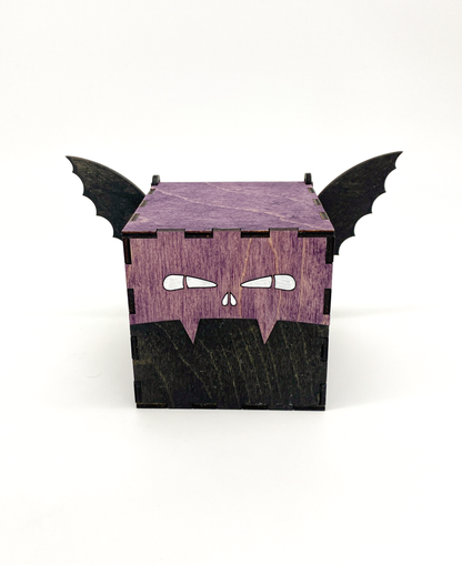 Wooden box designed to look like a bat with black wings on a white background