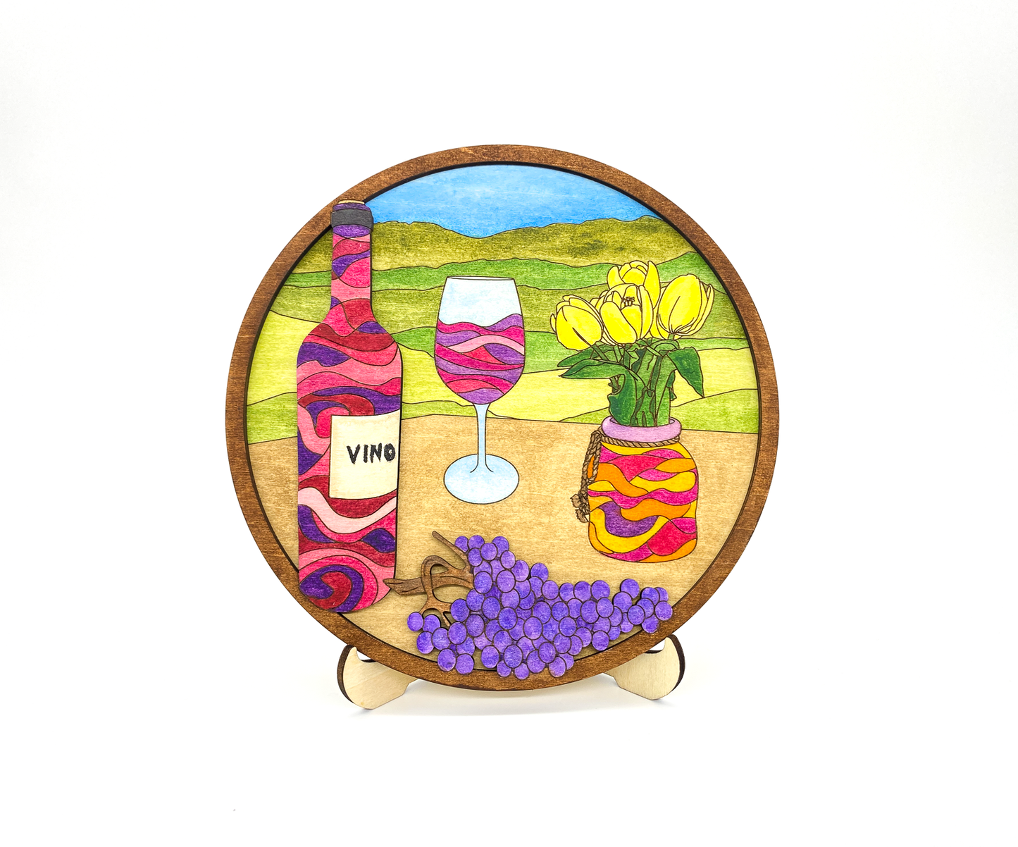 Finished 3D layered wood painting of a wine bottle and tulips in a 6-inch circular frame on a white background