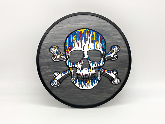 Decorative wall art with a colorful skull and crossbones design on a gray background