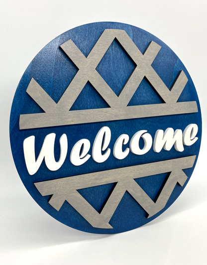 Decorative sign with 'Welcome' text on a blue and silver design