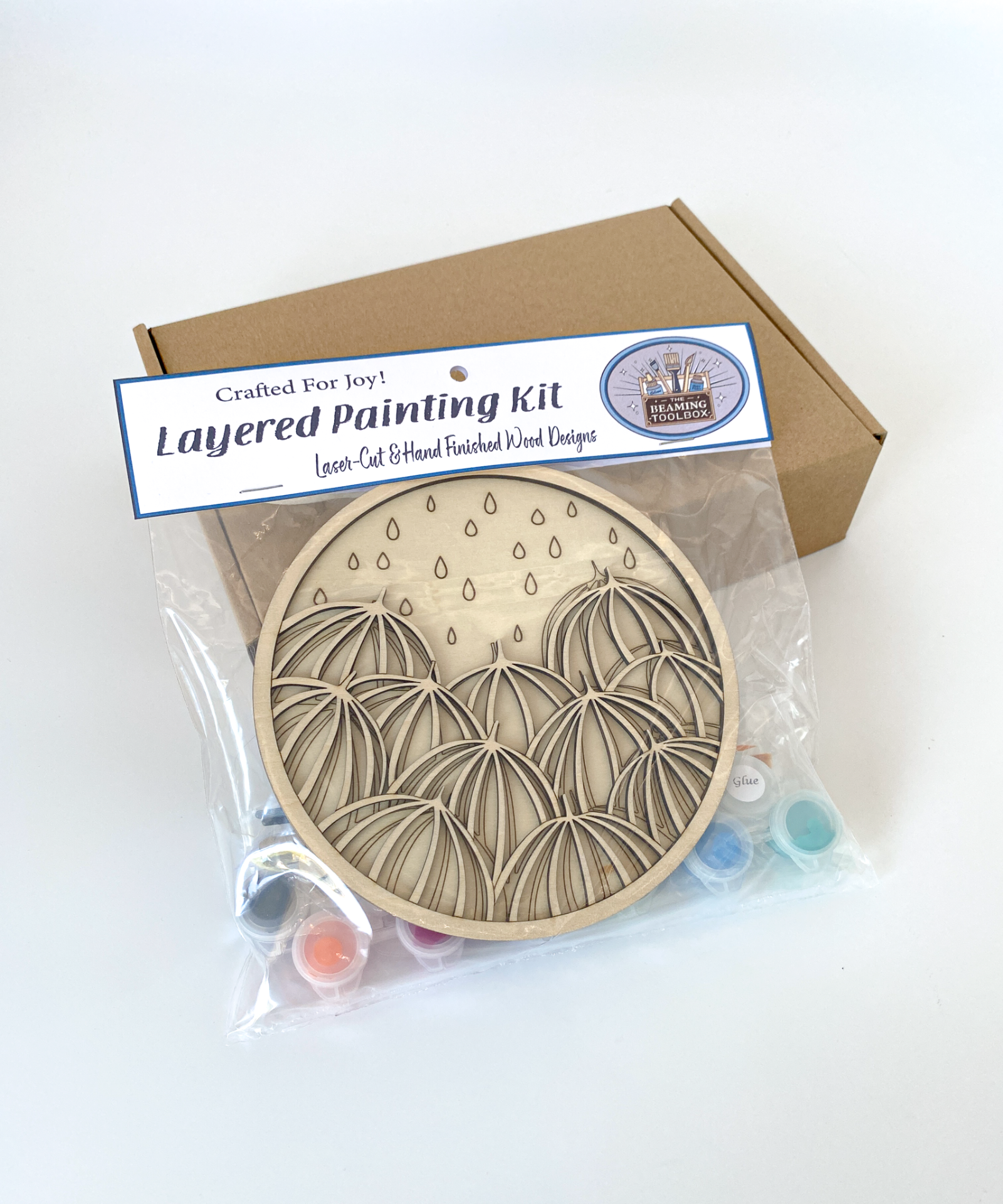 Layered painting kit with wooden craft kit and packaging on a white background