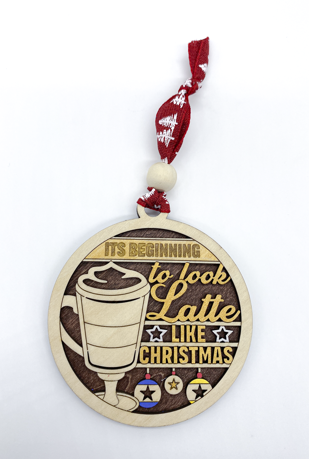 Decorative Christmas ornament with a latte design and text on a white background