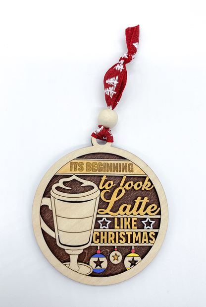 Decorative Christmas ornament with a latte design and text on a white background