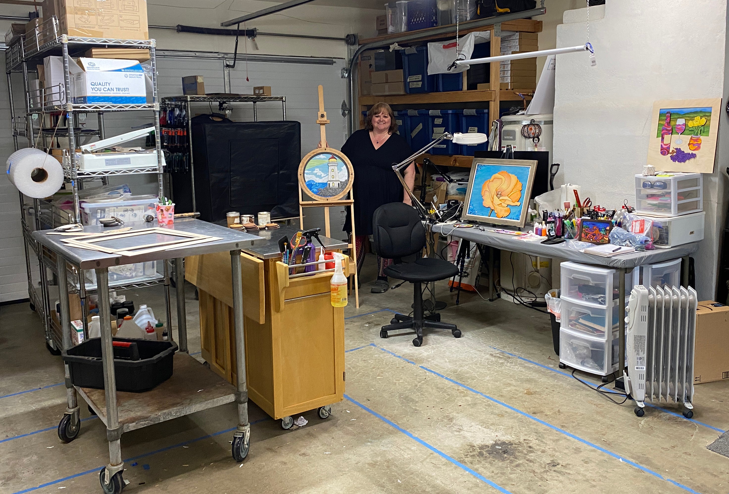 Workshop or studio with various equipment and Laura Loucks the artist in the background
