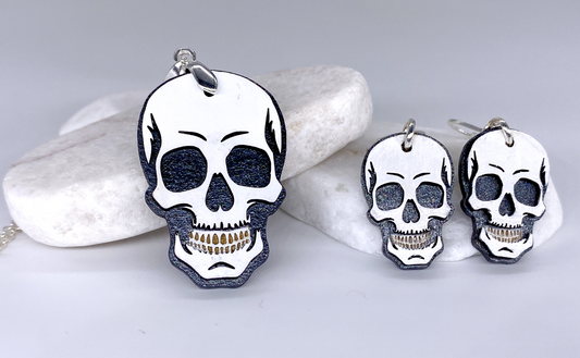 Skull-shaped earrings on a light gray background
