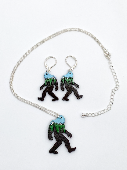 Necklace and earrings with sasquatch design on a white background