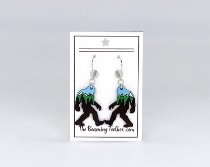 Sasquatch earrings on a card with 'The Beaming Toolbox' branding