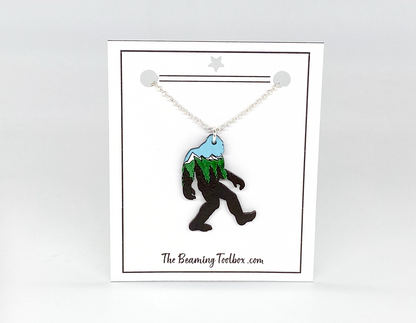 Necklace with a Bigfoot pendant on a white card with 'The Beaming Toolbox' branding.