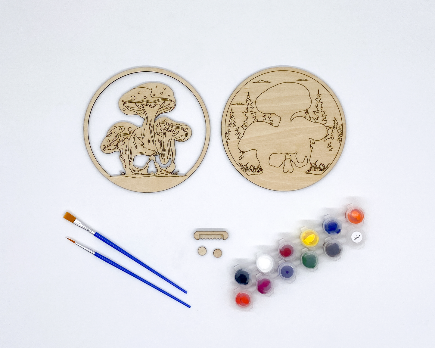 Mushroom and Skull Layered Wood Art kit, showing both layers, sawtooth hanger and bumers, two paint strips and two paint brutshes.