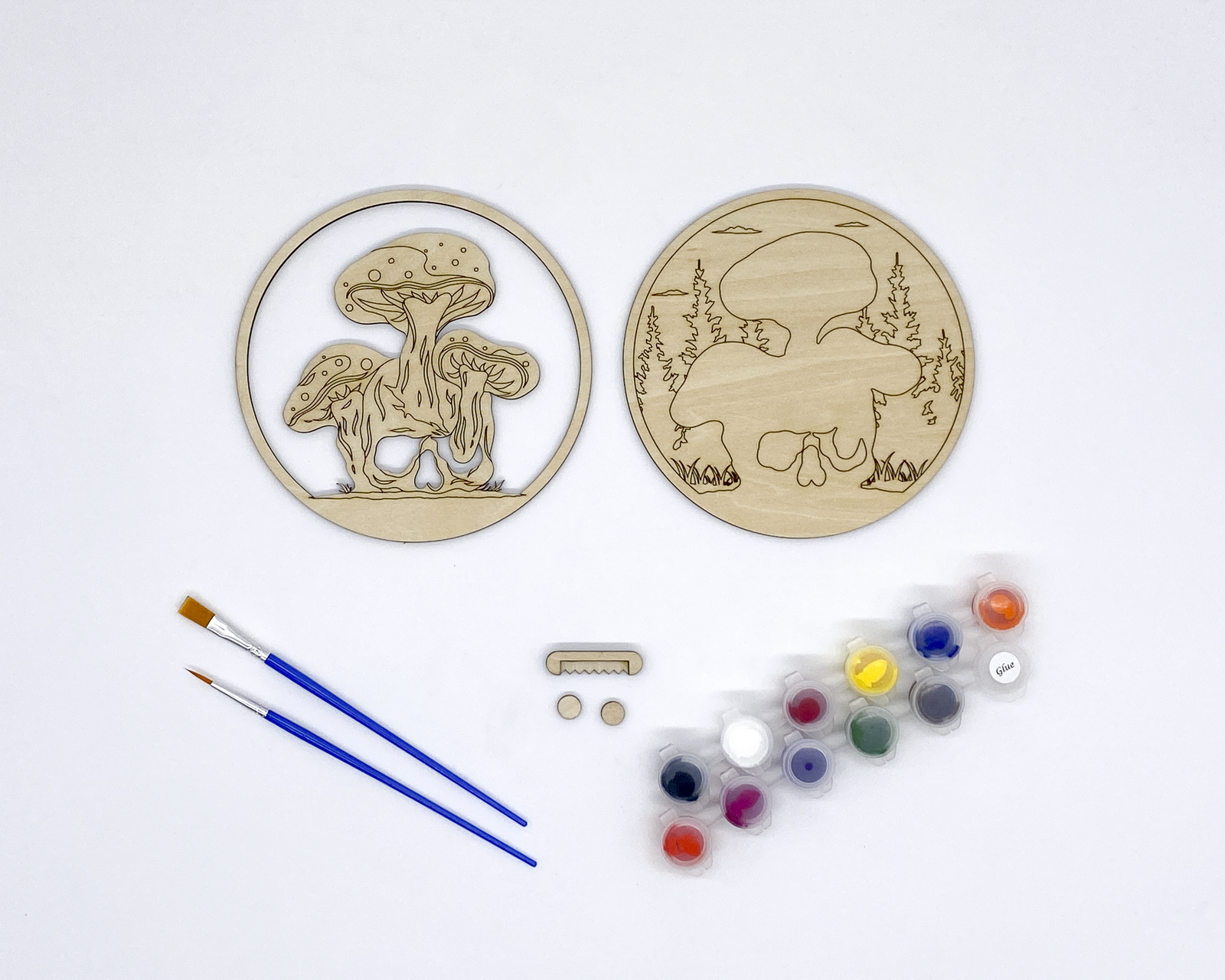 Mushroom and Skull Layered Wood Art kit, showing both layers, sawtooth hanger and bumers, two paint strips and two paint brutshes.