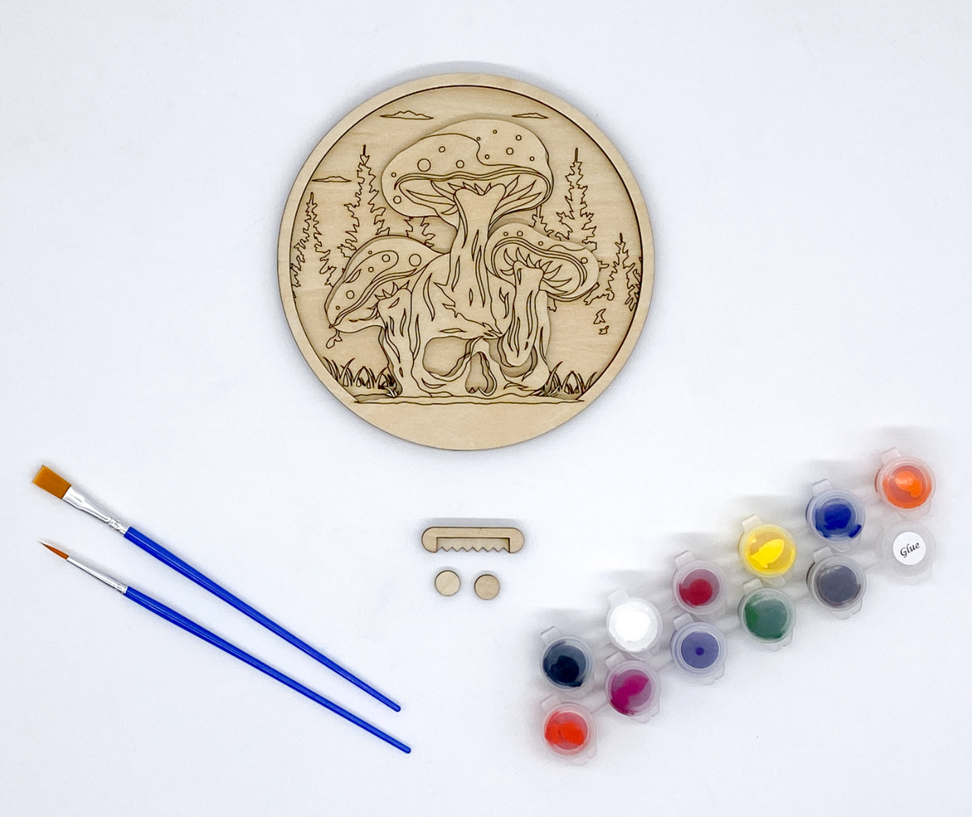 Mushroom and Skull Layered Wood Art kit, showing both layers combined, sawtooth hanger and bumers, two paint strips and two paint brutshes.