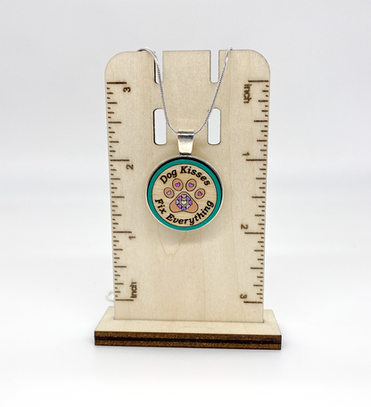 Detailed view of engraved Baltic birch wood pendant with silver-plated bezel and hand-painted design