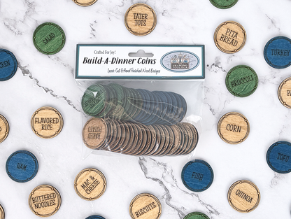 Packaged Build-A-Dinner Coins surrounded by color-coded wooden protein, vegetable, and side meal choices.