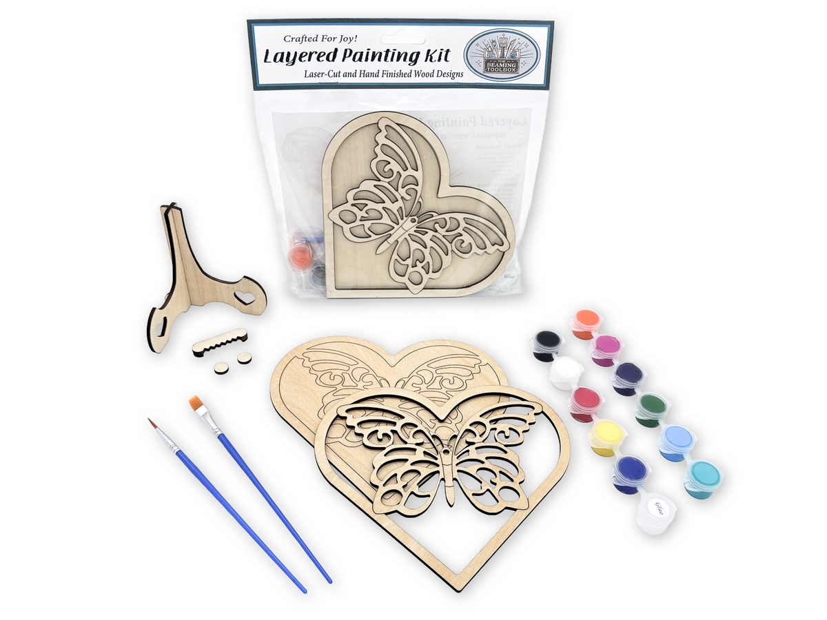 Butterfly heart layered painting kit sealed in packaging with the unfinished wood design visible through the clear bag.