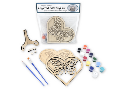 Butterfly heart layered painting kit sealed in packaging with the unfinished wood design visible through the clear bag.