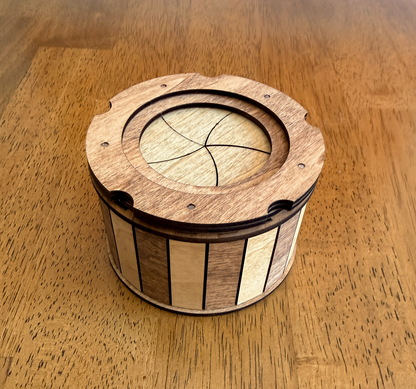Handcrafted wooden keepsake box displayed on a tabletop featuring a smooth twist-open iris mechanism and natural hardwood design.