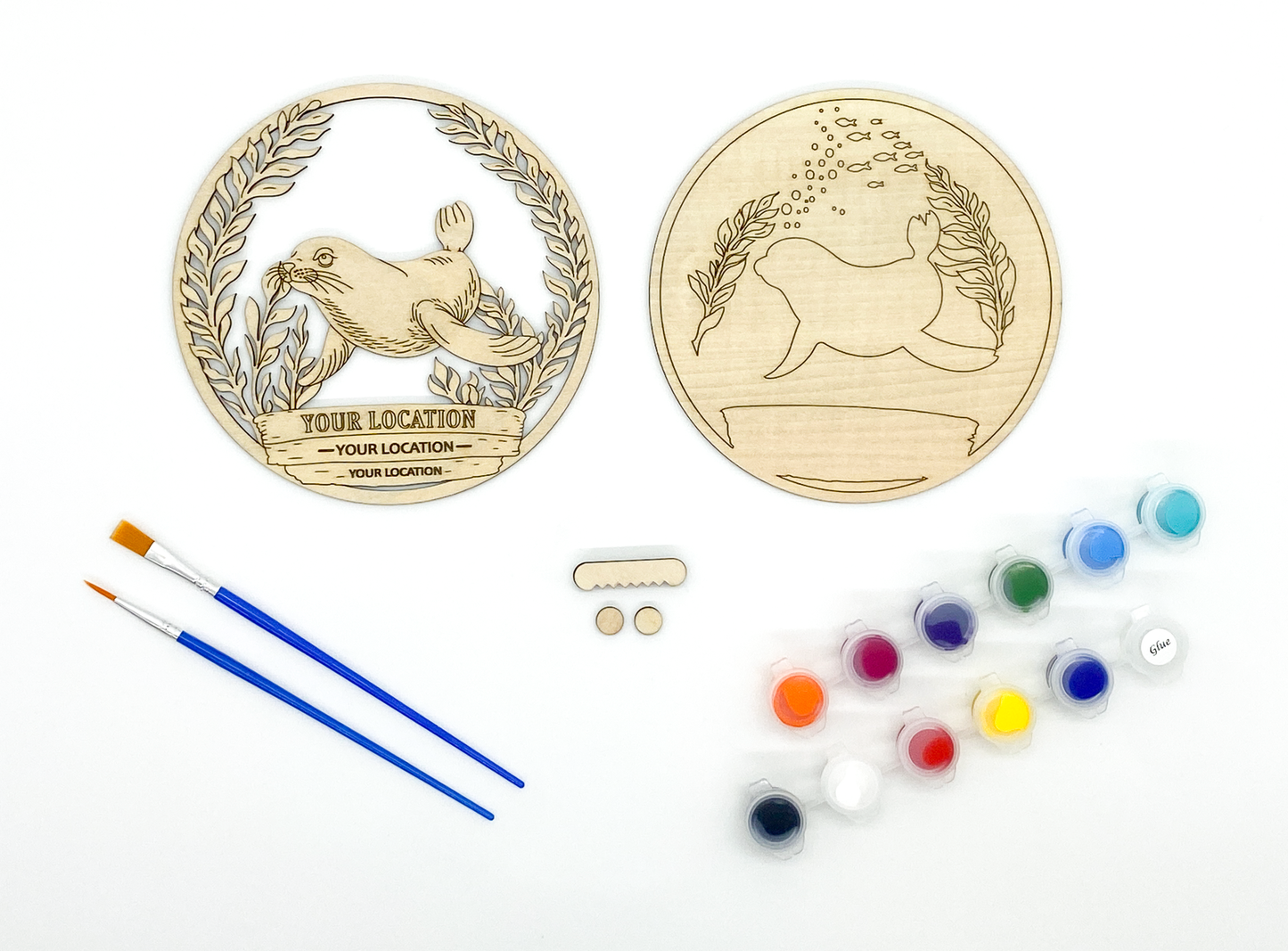 Custom sea lion DIY paint kit styled in coastal setting with craft supplies and finished piece displayed