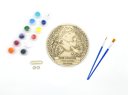 Custom sea lion DIY paint kit with unpainted layers laid flat alongside paints, brushes and hanger hardware