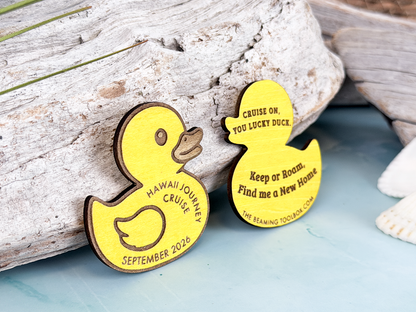 Front and back view of personalized yellow wooden cruise duck tokens with custom cruise name, date, and engraved hiding message.