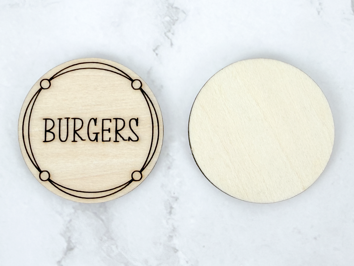 Front and back of a wooden Dinner Decision Coin showing an engraved burgers design and smooth unfinished reverse side.