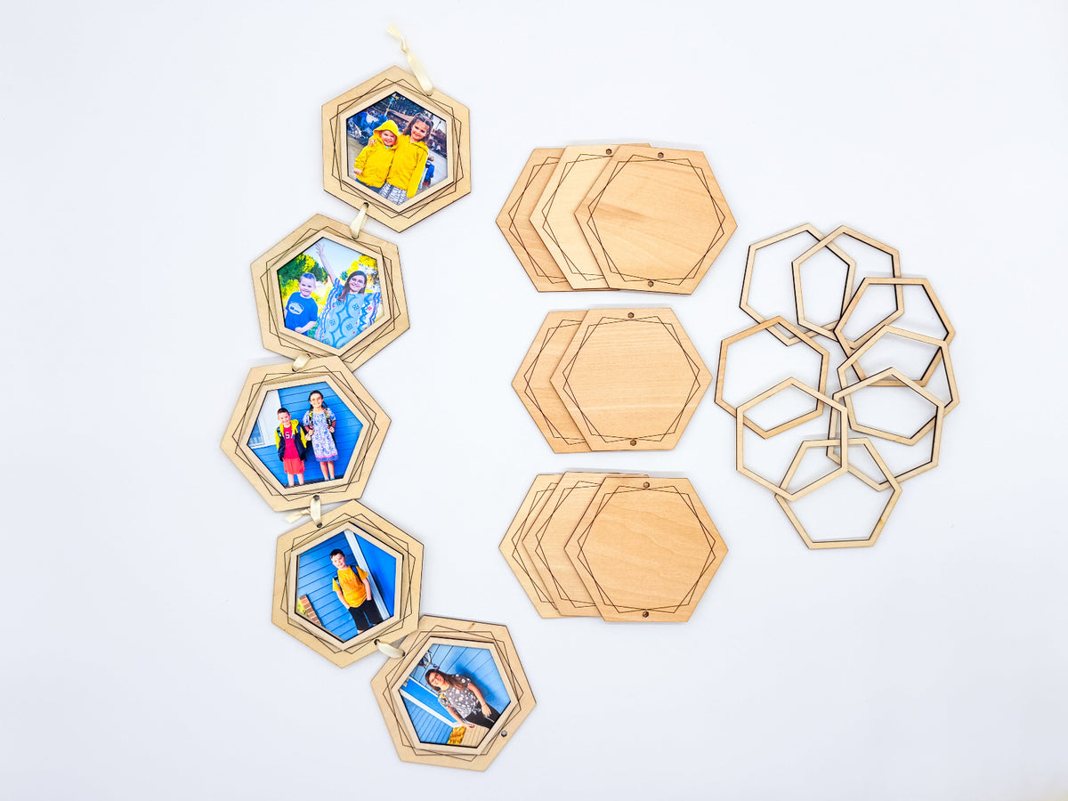 Five finished wooden hexagon photo frames connected with ribbon, displayed beside unassembled hexagon backings and open wooden frames on a white background.