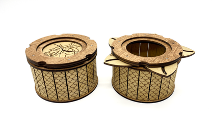 Dragon keepsake box shown closed and opened to display the mechanical iris opening system.