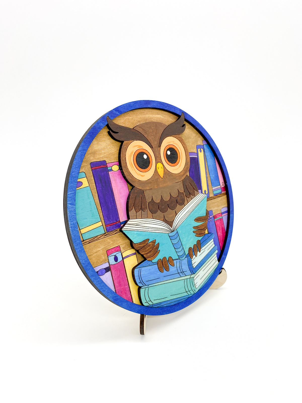 Completed painted owl diy kit with bright colorful colors, on a angled view