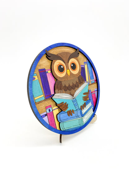 Completed painted owl diy kit with bright colorful colors, on a angled view