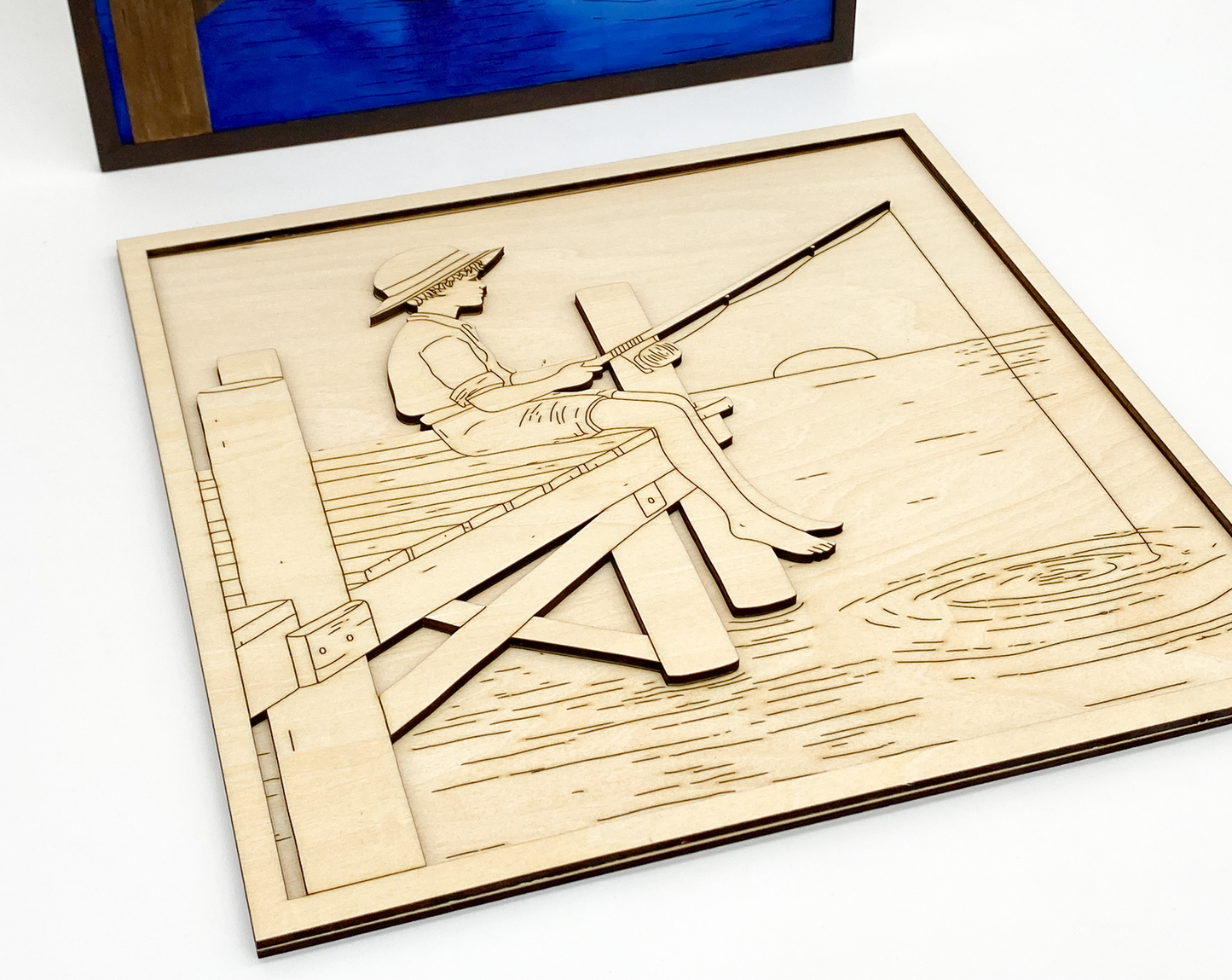 Close-up of painted fishing boy kit showing layered wood details