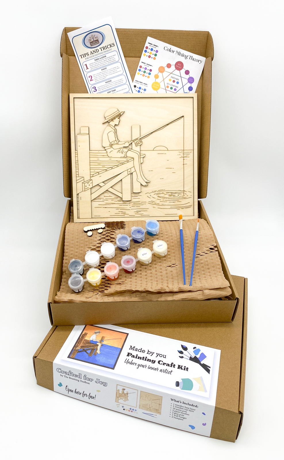 Painting craft kit with art supplies and instructions on a white background