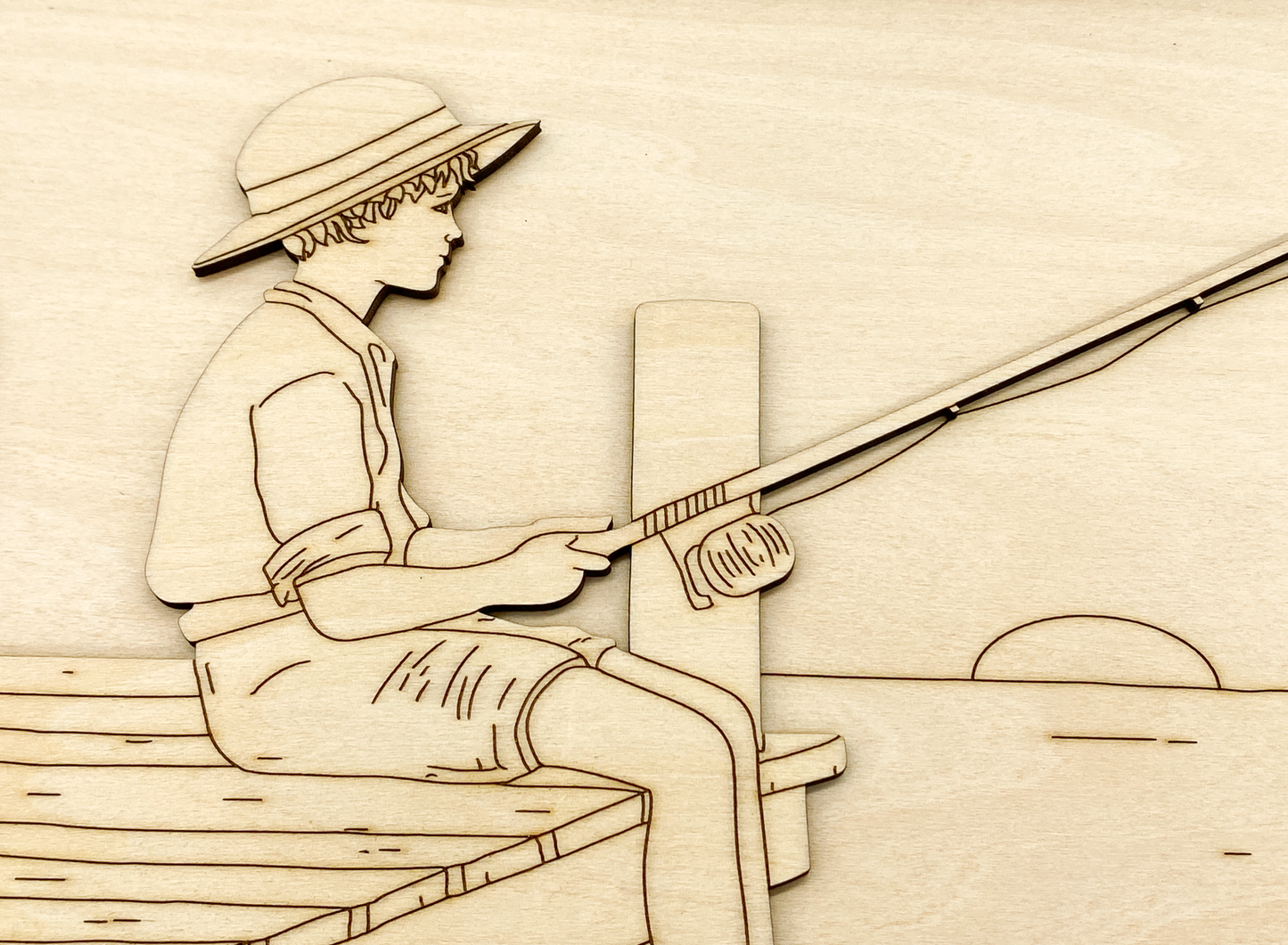 Close-up of painted fishing boy kit showing layered wood detail 