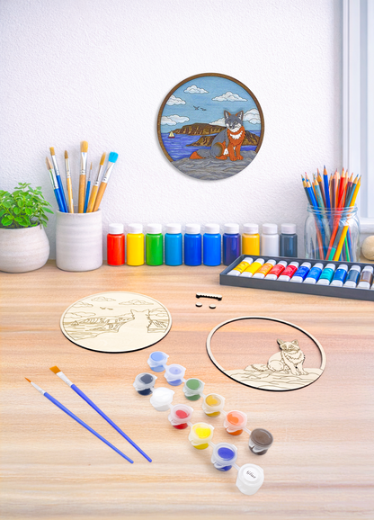 Fox coastal DIY paint kit on wood desk with paints, brushes, plant and art supplies with finished piece displayed on wall