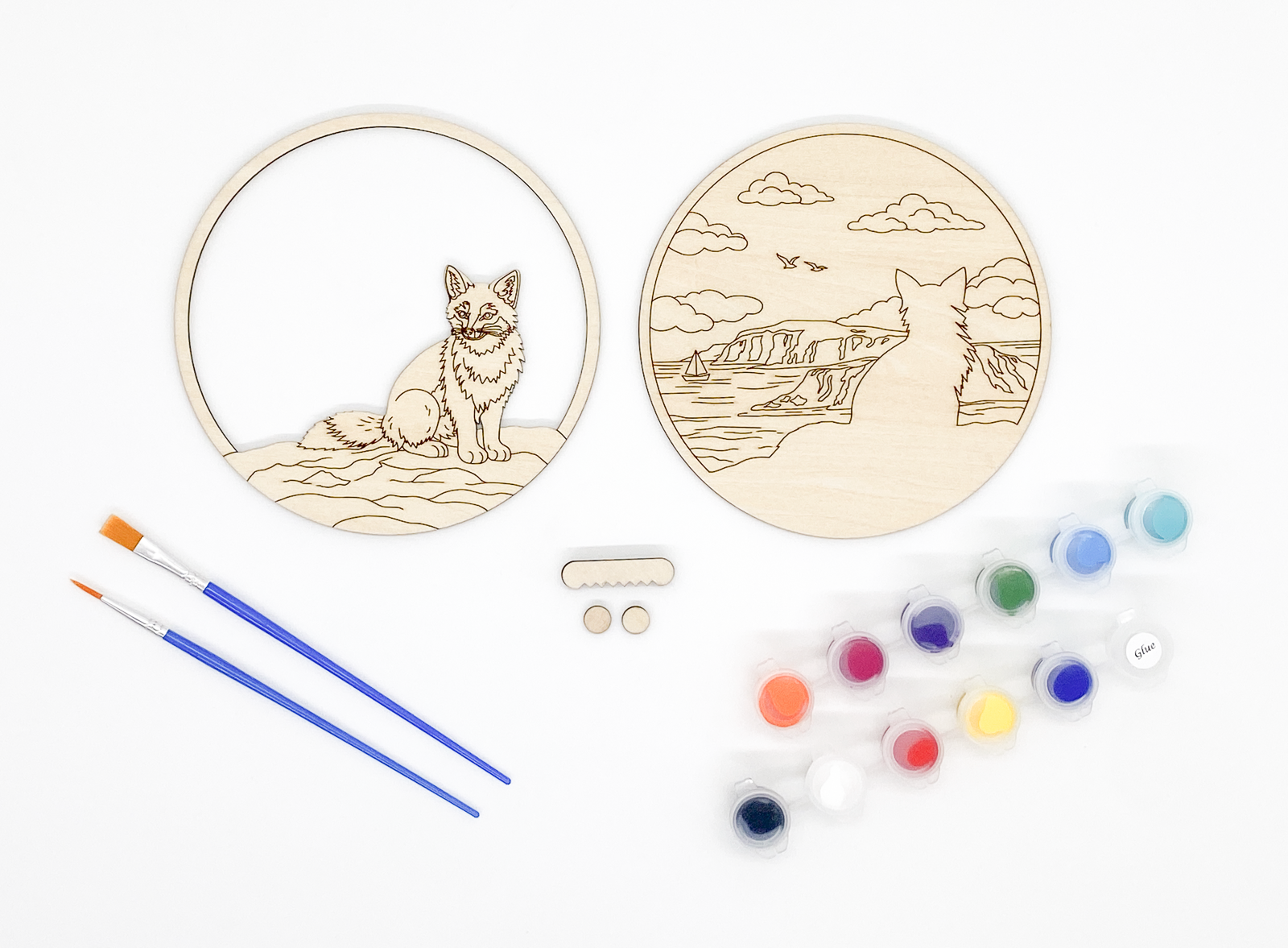 Fox DIY paint kit with unpainted layers laid flat alongside paints, brushes and hanger hardware