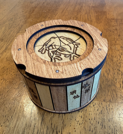Angled view of the Frog Keepsake Box showing engraved frog lid and frog footprint details around the sides.