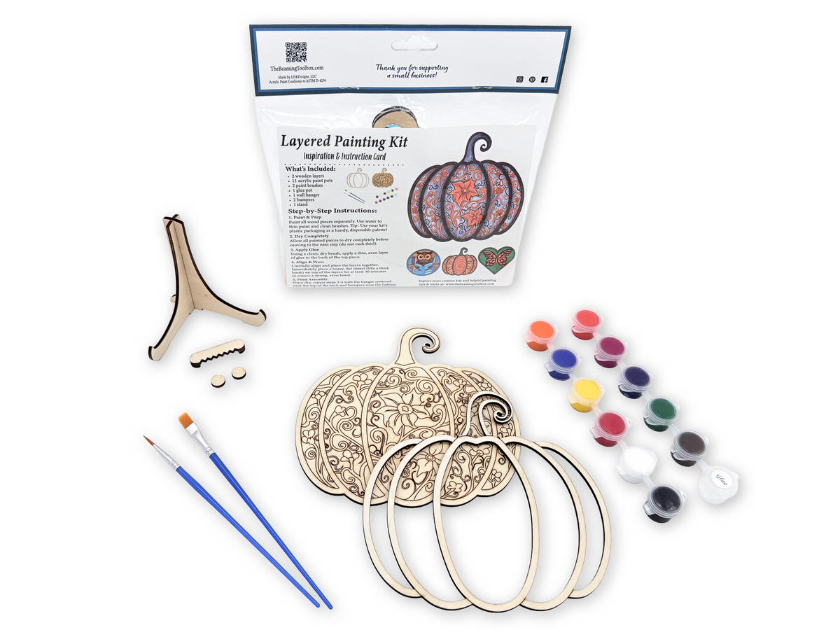 Gothic Pumpkin layered painting kit with unfinished wood pieces, paint pots, brushes, glue, display stand, hardware, and instruction card in packaging.