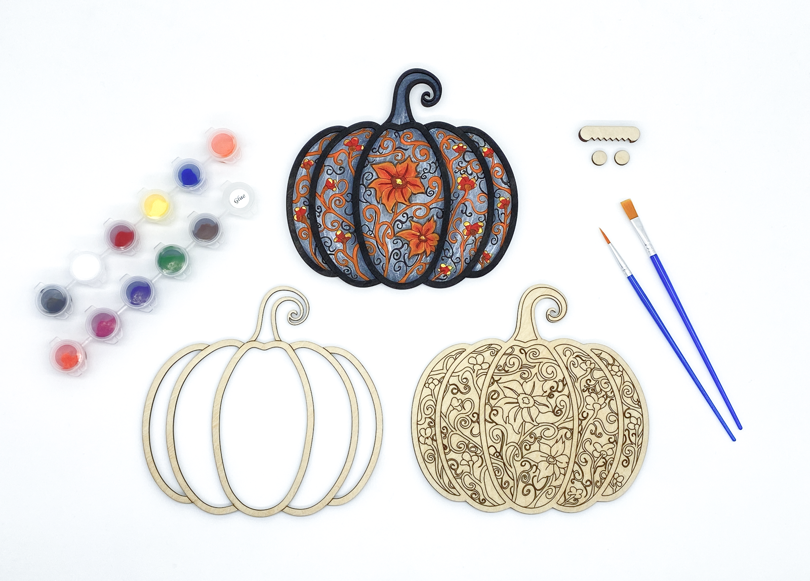 Complete gothic pumpkin DIY paint kit with finished piece, blank layers, paints, brushes and hardware side by side